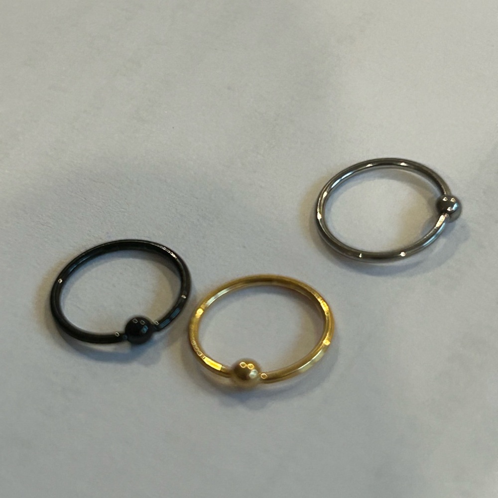 Elegant Gold, Silver, and Black Rings Set